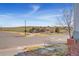 Neighborhood corner street view with landscaped hill and a glimpse of other houses at 4464 E 139Th Ave, Thornton, CO 80602