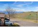 A neighborhood street scene shows a well-manicured lawn and distant mountain views on a clear day at 4464 E 139Th Ave, Thornton, CO 80602