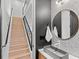 Modern bathroom with floating vanity, round mirror, and light wood accents at 2643 S Bannock St, Denver, CO 80223