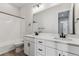 Modern bathroom with white cabinets, double vanity, and a shower/tub combo at 4125 River Oaks St, Castle Rock, CO 80104
