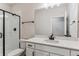 Modern bathroom with white vanity, shower, and mirror at 4125 River Oaks St, Castle Rock, CO 80104