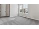 Well-lit bedroom featuring gray carpet, a closet, and large windows at 4125 River Oaks St, Castle Rock, CO 80104