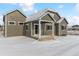 Gray house exterior with covered patio and snowy yard at 4125 River Oaks St, Castle Rock, CO 80104
