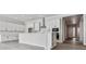 Modern kitchen with white shaker cabinets, large island, and stainless steel appliances at 4125 River Oaks St, Castle Rock, CO 80104