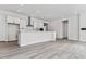 Open concept kitchen with white cabinets, large island, and stainless steel appliances at 4125 River Oaks St, Castle Rock, CO 80104