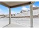 Covered patio overlooking snowy backyard and neighborhood at 4125 River Oaks St, Castle Rock, CO 80104