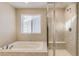 Bathroom with separate tub and glass enclosed shower at 13362 Amber Sky St, Parker, CO 80134