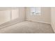 Bright, carpeted bedroom with a large window at 13362 Amber Sky St, Parker, CO 80134