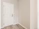 Inviting entryway featuring a white paneled door, light gray walls, and durable flooring at 13362 Amber Sky St, Parker, CO 80134