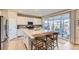 Kitchen with stainless steel appliances and island with barstool seating at 13362 Amber Sky St, Parker, CO 80134