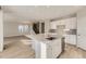 Open kitchen featuring quartz counters, large island, and stainless appliances at 13362 Amber Sky St, Parker, CO 80134