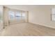 Bright, open living room with beautiful wood floors and large windows, offering ample natural light at 13362 Amber Sky St, Parker, CO 80134
