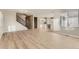 Spacious open-concept living room featuring hardwood floors, staircase and seamless flow into the kitchen at 13362 Amber Sky St, Parker, CO 80134
