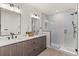 Elegant bathroom with double vanity, a glass shower, and modern fixtures at 1715 Grove St, Denver, CO 80204