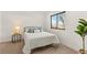 Cozy bedroom featuring a comfortable bed, stylish side table, and a bright window with a pleasant outside view at 1715 Grove St, Denver, CO 80204