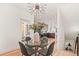 Bright dining room featuring a glass table, modern light fixture and an open view to the kitchen at 1715 Grove St, Denver, CO 80204