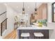 Modern kitchen with stainless steel appliances, a quartz countertop island with stools, and pendant lighting at 1715 Grove St, Denver, CO 80204