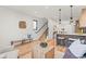 Living area featuring open floor plan, kitchen island, staircase, and stylish furniture at 1715 Grove St, Denver, CO 80204