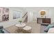 Open living area featuring comfortable sofas, stylish coffee tables, and convenient access to stairs and a bar area at 1715 Grove St, Denver, CO 80204