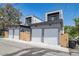 Rear exterior of modern homes with multiple garage doors and stylish architectural design at 1715 Grove St, Denver, CO 80204