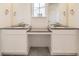 Bathroom featuring double vanity sinks with stone countertops and modern fixtures at 39856 Floyd St, Elizabeth, CO 80107