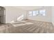 Inviting bedroom featuring three large windows, neutral carpet, and ample natural light at 39856 Floyd St, Elizabeth, CO 80107