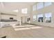 Spacious living room featuring tall windows, hardwood floors, and an open floor plan at 39856 Floyd St, Elizabeth, CO 80107