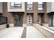 Modern townhome exterior showcasing brick facade, clean lines, and private entryway with professional landscaping at 4044 W 16Th Ave, Denver, CO 80204