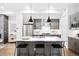 Stylish kitchen features gray cabinetry, stainless steel appliances, a center island with bar seating, and modern pendant lights at 4044 W 16Th Ave, Denver, CO 80204