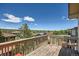 Inviting back deck boasts wooden railings and panoramic views of the neighborhood and mountains beyond at 10528 Applebrook Cir, Highlands Ranch, CO 80130