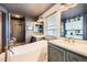 Stylish bathroom featuring a freestanding tub, decorative tile flooring, and dual vanities at 10528 Applebrook Cir, Highlands Ranch, CO 80130