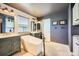 Elegant bathroom featuring a freestanding tub, decorative tile flooring, dual vanities, and stylish fixtures at 10528 Applebrook Cir, Highlands Ranch, CO 80130
