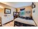 Cozy bedroom featuring a comfortable bed, dresser, desk area and natural light from a window at 10528 Applebrook Cir, Highlands Ranch, CO 80130