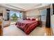 Serene main bedroom featuring a private balcony, tray ceiling, and a cozy sitting area at 10528 Applebrook Cir, Highlands Ranch, CO 80130