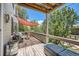 Inviting outdoor deck featuring comfortable seating, shade sail, and wooded views at 10528 Applebrook Cir, Highlands Ranch, CO 80130