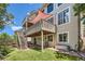 Multi-story home with deck, stone patio, and well-maintained backyard at 10528 Applebrook Cir, Highlands Ranch, CO 80130