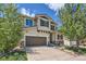 Charming two-story home features a well-maintained front lawn, mature trees, and a two-car garage at 10528 Applebrook Cir, Highlands Ranch, CO 80130