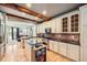 Well-lit kitchen with granite countertops, brick backsplash, and stainless steel appliances opens to living area at 10528 Applebrook Cir, Highlands Ranch, CO 80130