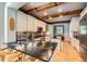 Modern kitchen with sleek black countertops, brick backsplash, wooden beams, and stainless steel appliances at 10528 Applebrook Cir, Highlands Ranch, CO 80130