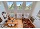 Spacious living room with high ceilings, large windows, hardwood floors, a fireplace, and ample natural light at 10528 Applebrook Cir, Highlands Ranch, CO 80130
