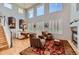 Bright living room boasts high ceilings, a fireplace, and an open floor plan, seamlessly connecting living and dining spaces at 10528 Applebrook Cir, Highlands Ranch, CO 80130