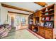 Spacious living room with exposed beams, built-in shelving, and an open floorplan at 10528 Applebrook Cir, Highlands Ranch, CO 80130