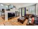 Comfortable living room with a stone fireplace, leather furniture, and natural light from sliding glass doors at 10528 Applebrook Cir, Highlands Ranch, CO 80130