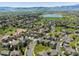 Expansive aerial view of a residential neighborhood with a lake and mountain backdrop at 13804 W 61St Cir, Arvada, CO 80004