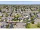 Expansive aerial view of a residential neighborhood filled with lush trees and well-maintained homes at 13804 W 61St Cir, Arvada, CO 80004