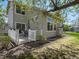 Relaxing backyard with wooden deck, patio furniture, mature trees, and well-maintained lawn at 13804 W 61St Cir, Arvada, CO 80004