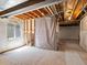 Spacious unfinished basement with exposed wood beams, a window and white insulation at 13804 W 61St Cir, Arvada, CO 80004