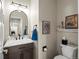 Powder room featuring a vanity with marble countertop and modern fixtures at 13804 W 61St Cir, Arvada, CO 80004
