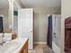 Neutral bathroom with a shower, white tile and wood vanity, and neutral tile floors at 13804 W 61St Cir, Arvada, CO 80004