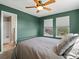 Calming bedroom featuring two bright windows, a ceiling fan and an iron bedframe at 13804 W 61St Cir, Arvada, CO 80004